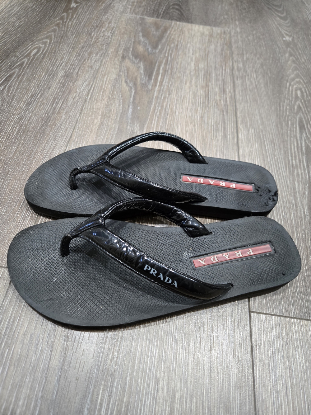 Prada Black Men’s Logo Strap Flip Flops with Red Logo Accents